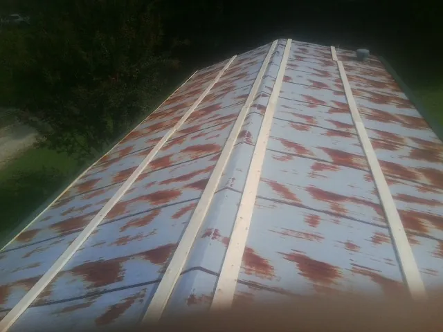 Rusted metal roof panels with new wood purlins before replacement — Storm Damage Roof Repair in Potlatch by Roofing Brothers