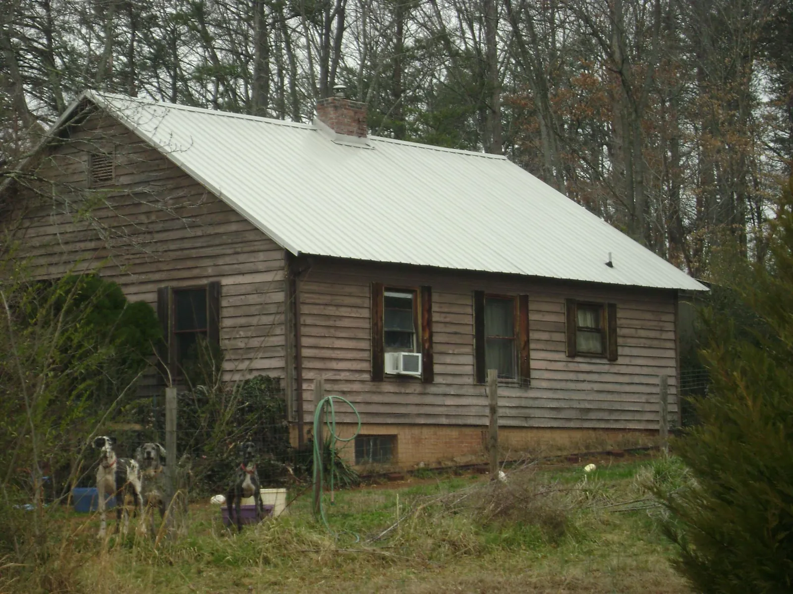White metal roof on an old wood sided farmhouse, from a Metal Roof Installation job in Potlatch